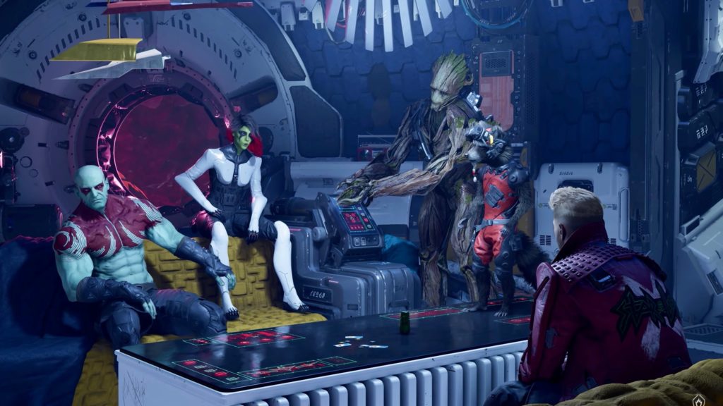 Screenshot aus Guardians of the Galaxy. Team sitzt im Raumschiff rund um einen Tisch.